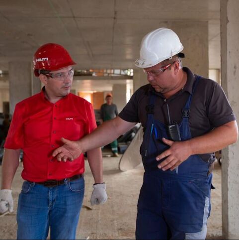 Two handymen working on electrical service in Arlington, Texas.